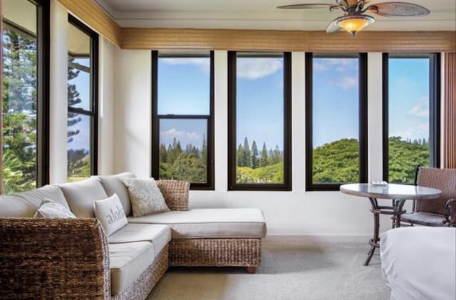 sunroom featuring ceiling fan