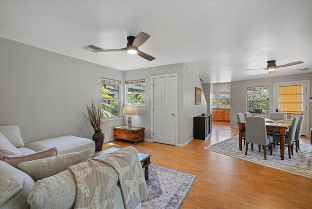 33 Hoku Pl, Paia, HI 96779 - living room with a ceiling fan, light wood finished floors, and baseboards