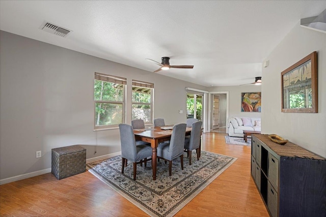 33 Hoku Pl, Paia, HI 96779 - dining area featuring a ceiling fan, light wood-style flooring, and baseboards