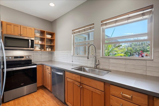33 Hoku Pl, Paia, HI 96779 - kitchen with appliances with stainless steel finishes, a sink, light wood finished floors, tasteful backsplash, and recessed lighting