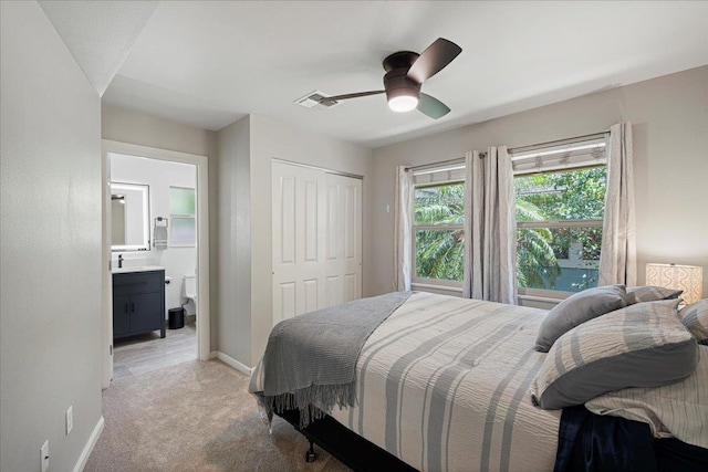 33 Hoku Pl, Paia, HI 96779 - bedroom featuring light colored carpet, baseboards, a closet, ensuite bath, and ceiling fan
