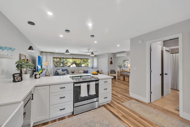 kitchen with kitchen peninsula, light wood-type flooring, electric stove, white cabinetry, and hanging light fixtures