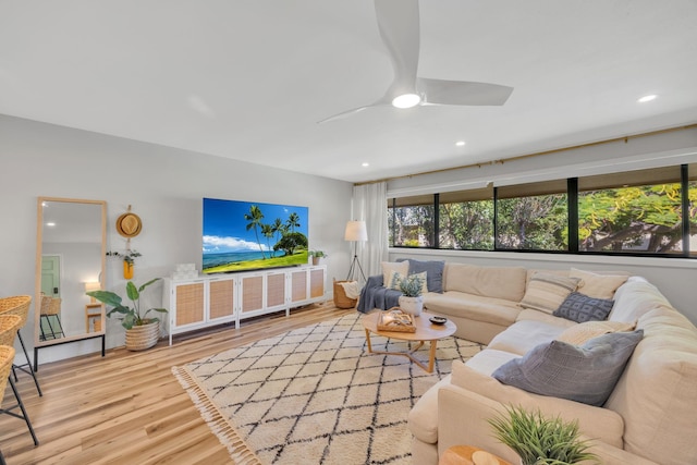 living room with hardwood / wood-style flooring and ceiling fan