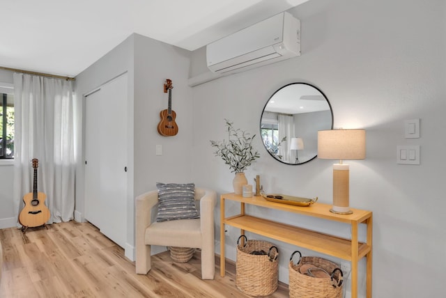 entryway featuring a wall mounted air conditioner and light hardwood / wood-style flooring