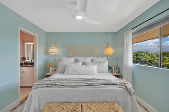 bedroom featuring ceiling fan, sink, and ensuite bathroom