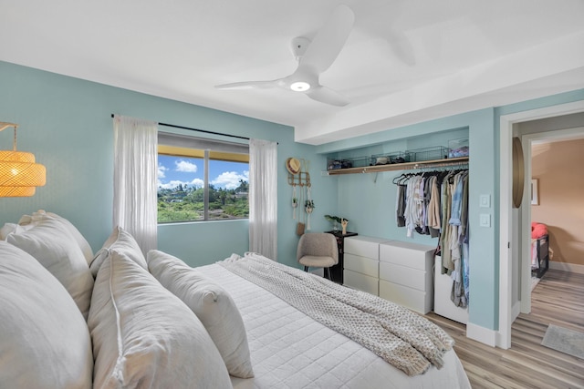 bedroom featuring light hardwood / wood-style floors, a closet, and ceiling fan