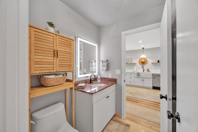 bathroom with tile patterned flooring, vanity, and toilet