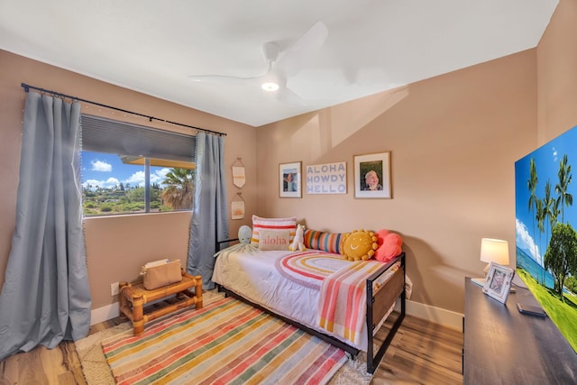 bedroom with ceiling fan and wood-type flooring