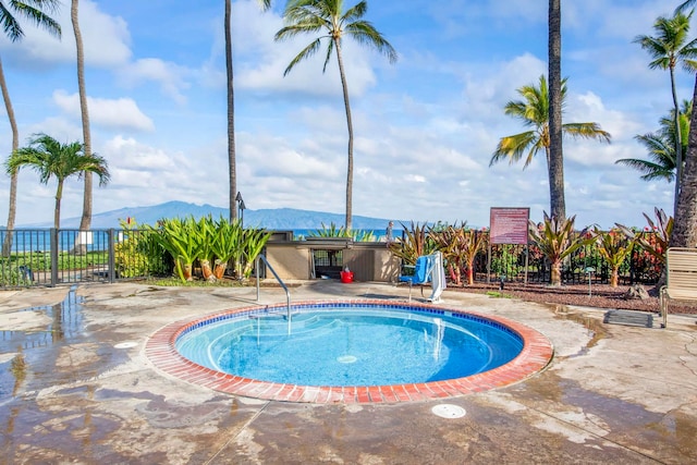 view of swimming pool featuring a mountain view and a patio