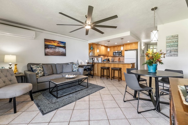 living room featuring ceiling fan, a wall mounted AC, a textured ceiling, and light tile patterned floors