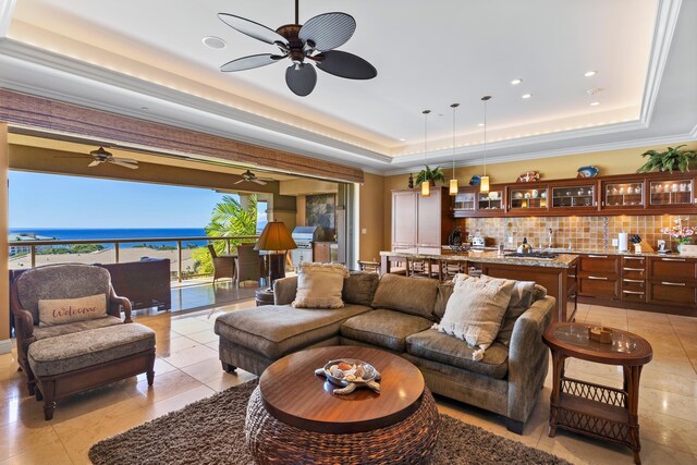 view of patio featuring outdoor dining area, a balcony, area for grilling, a water view, and exterior kitchen