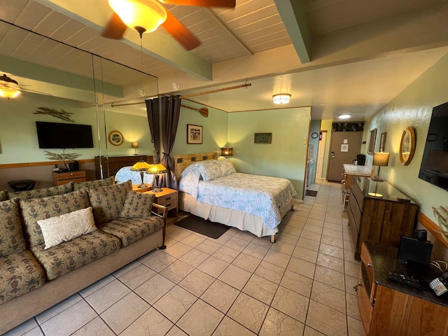 tiled bedroom featuring beam ceiling, wooden ceiling, and ceiling fan