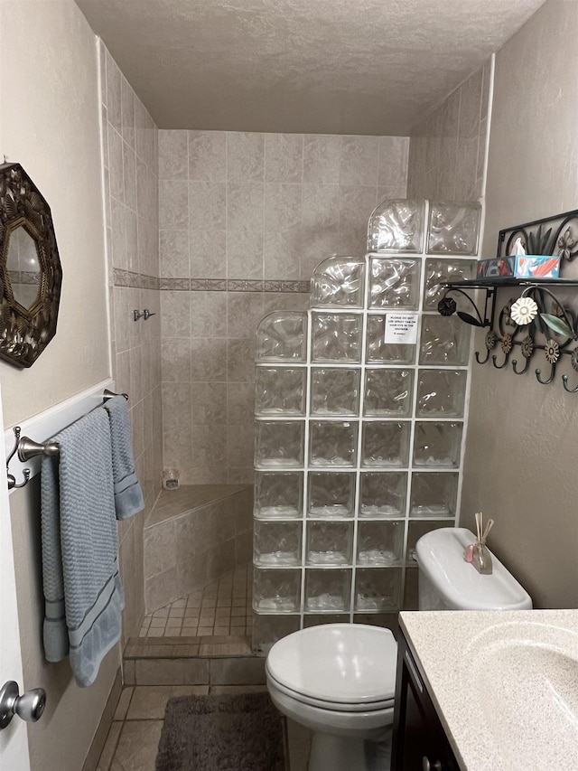 715 S Kihei Rd Unit D144, Kihei, HI 96753 - bathroom with a walk in shower, toilet, vanity, tile patterned floors, and a textured ceiling
