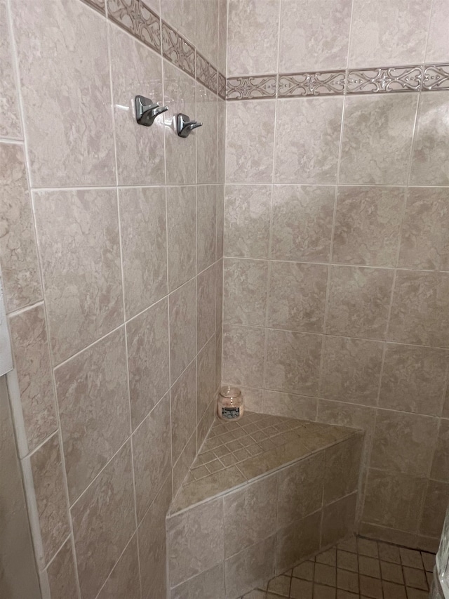 bathroom with a tile shower