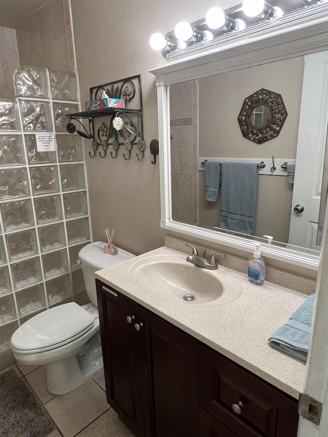 bathroom with vanity, toilet, and tile patterned flooring