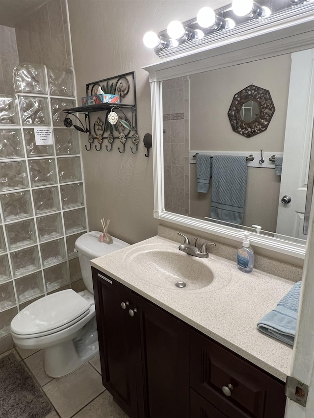 715 S Kihei Rd Unit D144, Kihei, HI 96753 - bathroom featuring vanity, walk in shower, toilet, tile patterned flooring, and a textured wall