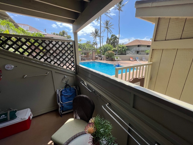 view of patio / terrace featuring a fenced in pool and a balcony