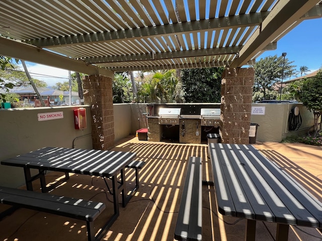 view of patio featuring a pergola, grilling area, and exterior kitchen