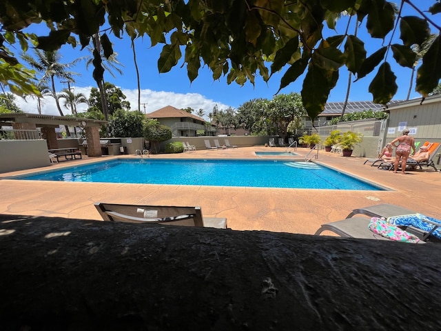 view of swimming pool with a patio