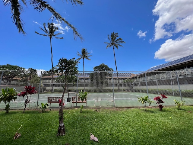 view of sport court featuring a lawn