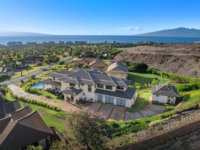 drone / aerial view featuring a water and mountain view