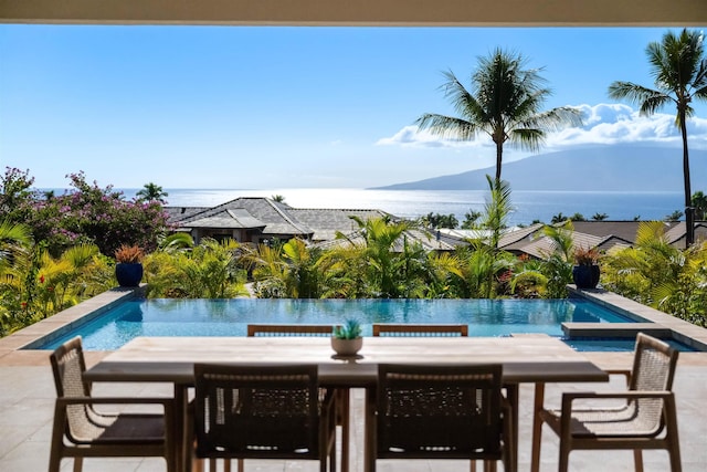 view of swimming pool with a patio area and a mountain view