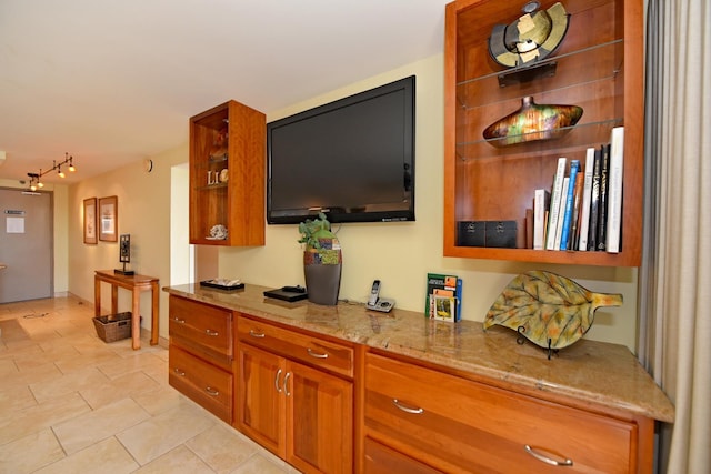 4327 Lower Honoapiilani Rd Unit 1203, Lahaina, HI 96761 - kitchen featuring open shelves, brown cabinets, light stone countertops, light tile patterned flooring, and rail lighting