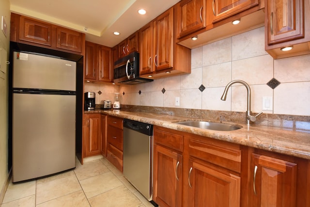 4327 Lower Honoapiilani Rd Unit 1203, Lahaina, HI 96761 - kitchen featuring stainless steel appliances, a sink, tasteful backsplash, brown cabinets, and light stone counters