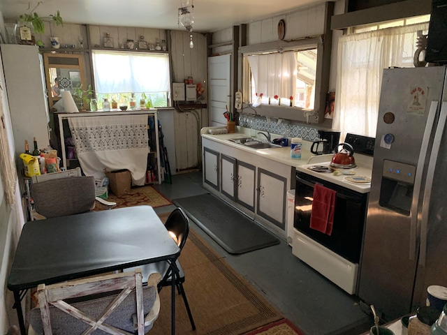 kitchen with sink, white electric range, and stainless steel fridge