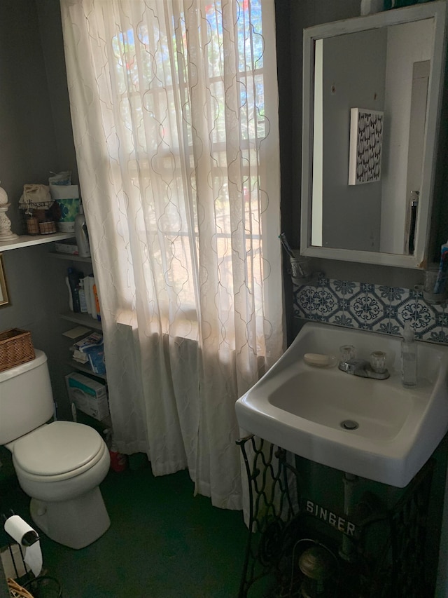 bathroom featuring sink and toilet