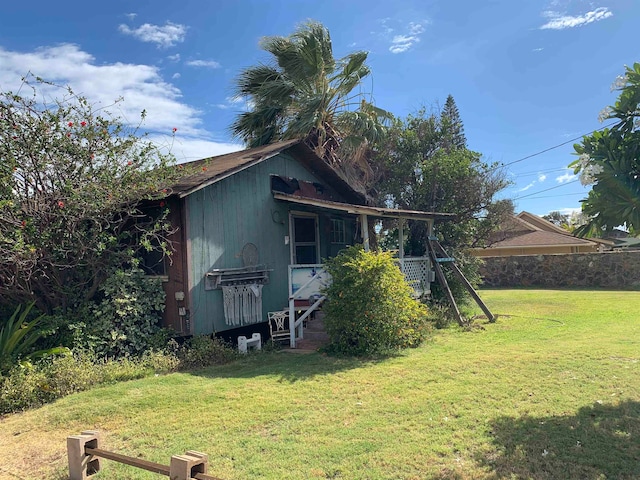 view of outbuilding featuring a yard