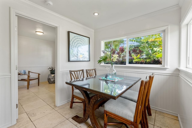 dining room with light tile patterned floors and ornamental molding