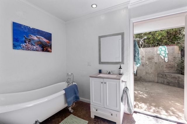 bathroom with vanity, crown molding, and a tub