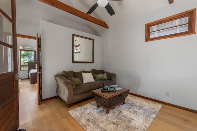 living room with ceiling fan, light wood-type flooring, and lofted ceiling