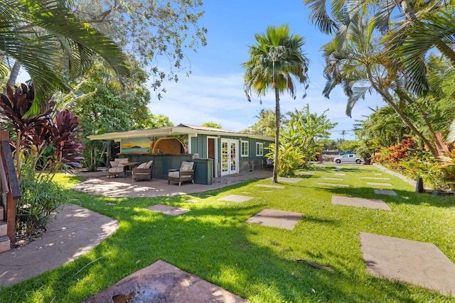 view of yard featuring a patio and french doors