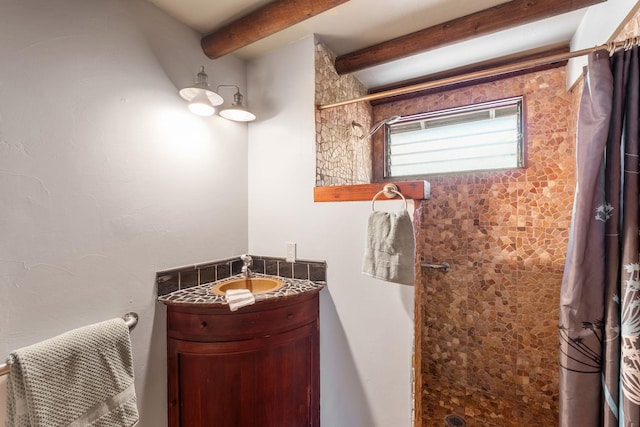 bathroom featuring curtained shower and vanity