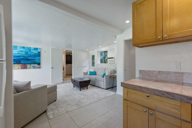 living room with beam ceiling and light tile patterned floors