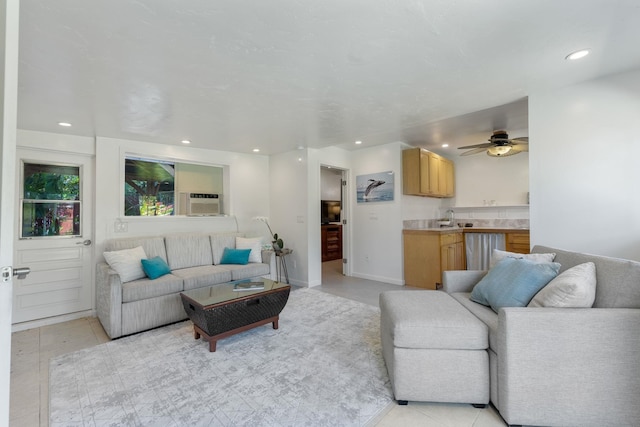 tiled living room featuring ceiling fan and sink