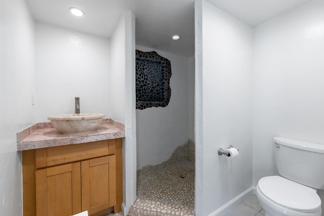 bathroom featuring tile patterned floors, vanity, and toilet