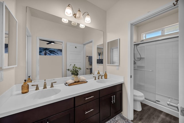 235 Kilioopu St, Wailuku, HI 96793 - bathroom featuring double vanity, toilet, wood finished floors, a shower, and a ceiling fan