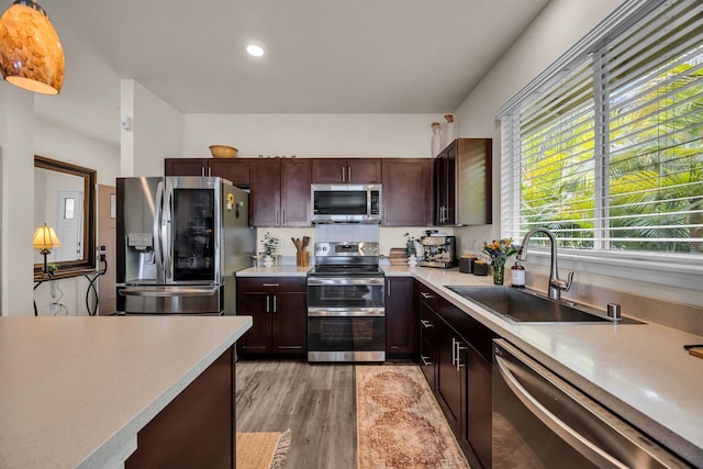 235 Kilioopu St, Wailuku, HI 96793 - kitchen with stainless steel appliances, a sink, light countertops, light wood-type flooring, and dark brown cabinets