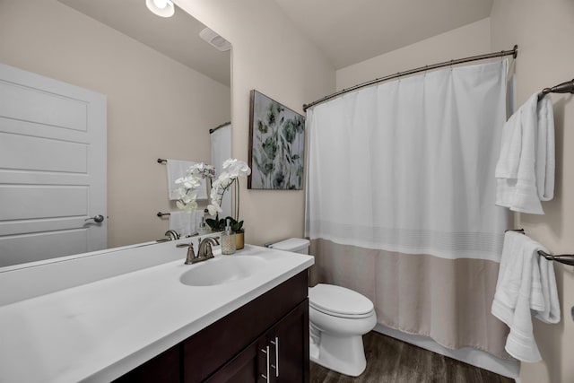 235 Kilioopu St, Wailuku, HI 96793 - bathroom featuring toilet, wood finished floors, vanity, and curtained shower