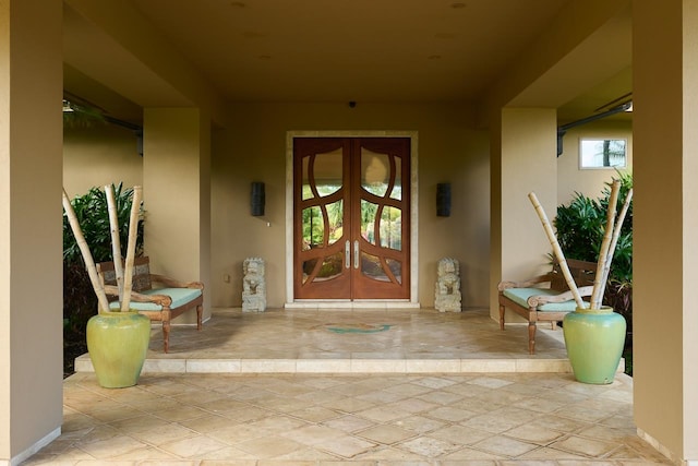 view of exterior entry featuring french doors and a patio area