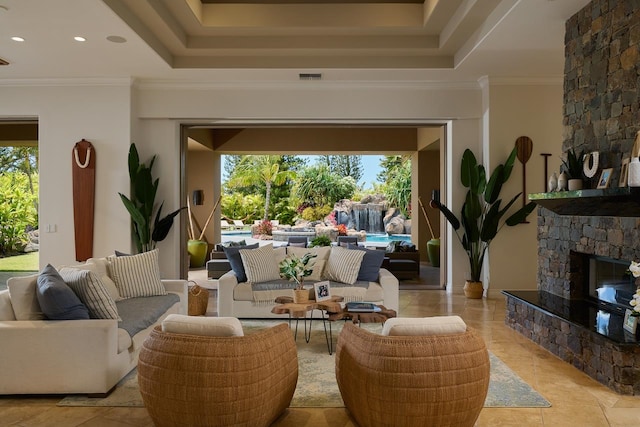 interior space featuring light tile patterned floors, crown molding, and a stone fireplace