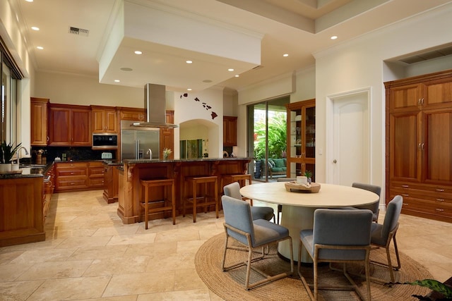 interior space with a high ceiling, ornamental molding, and sink