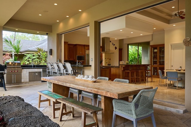 dining area featuring ceiling fan, light tile patterned flooring, and ornamental molding