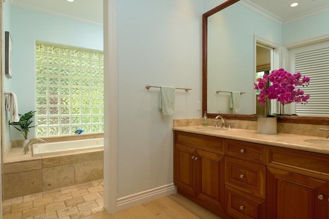 bathroom featuring hardwood / wood-style flooring, crown molding, a relaxing tiled tub, and dual vanity