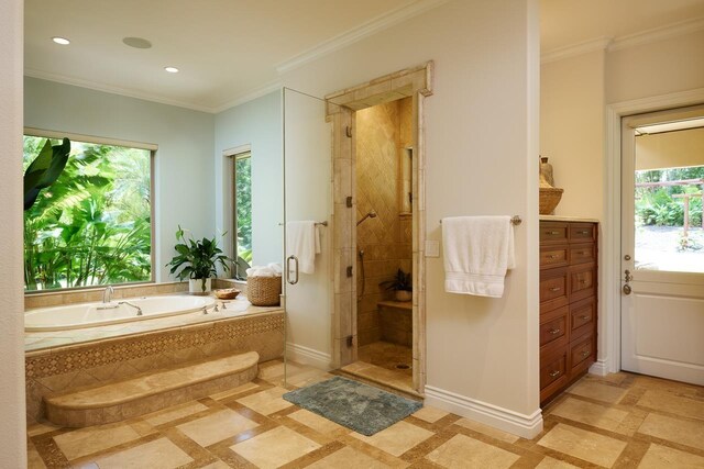 full bath with a shower stall, baseboards, crown molding, and a garden tub