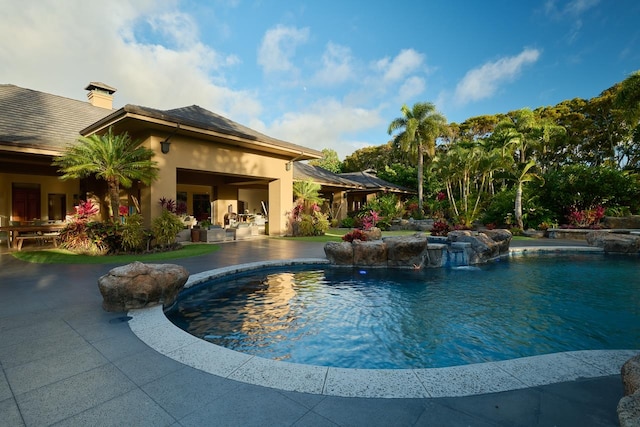 view of pool featuring pool water feature and a patio area