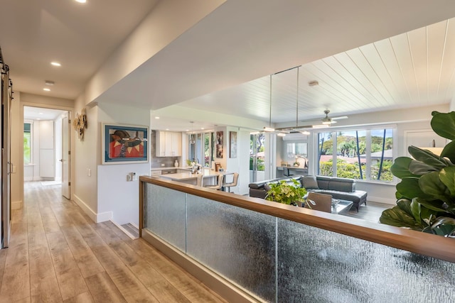 hall with light hardwood / wood-style floors